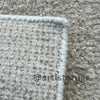 Picture of a rug featuring a glaze-like finish in sandy colors