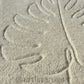 A rug featuring stencil-inspired leaves in earthy colors