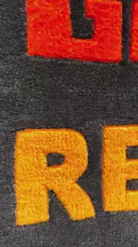 Detailed view of inspiring logo rugs