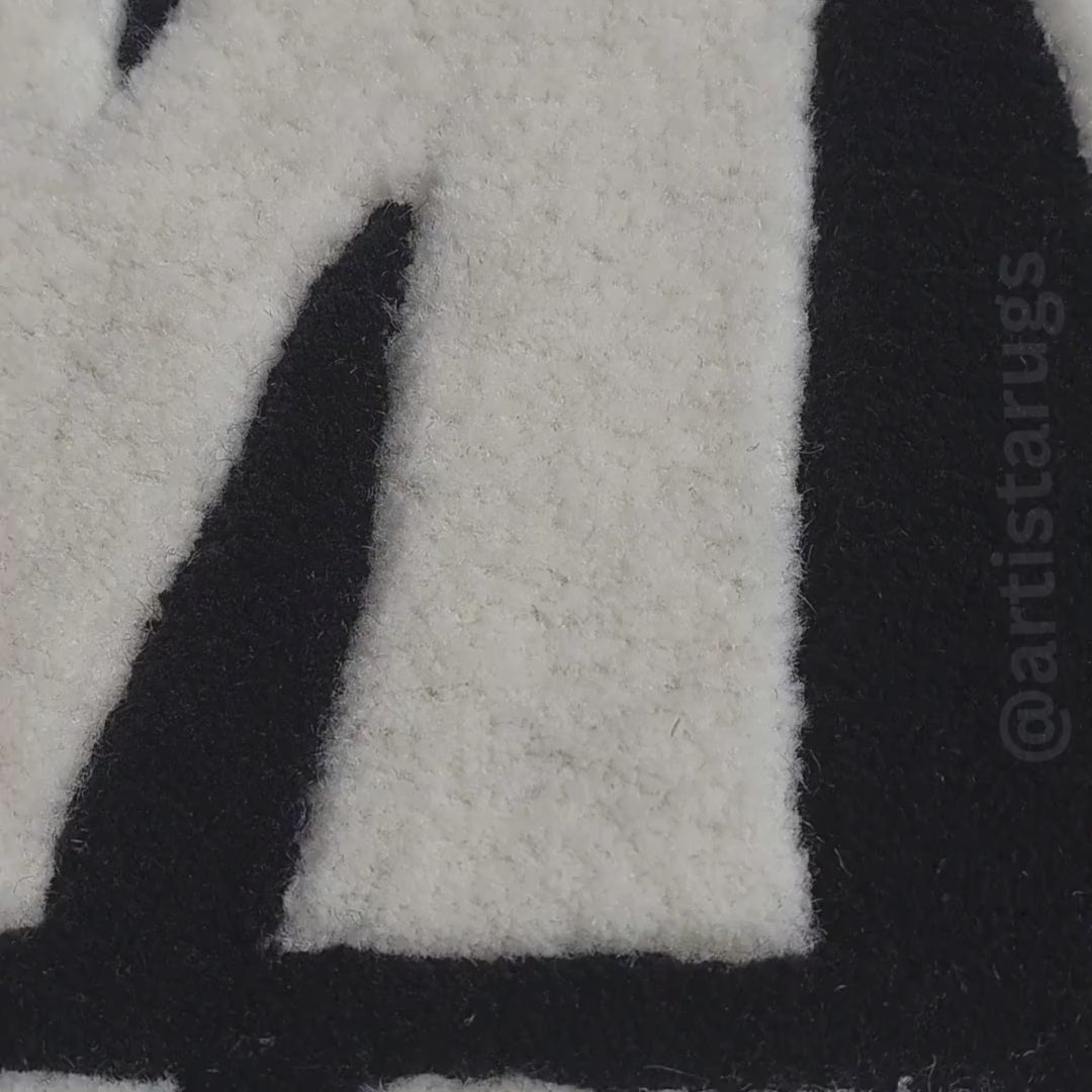 Aerial view of black Kiss My Airs rug