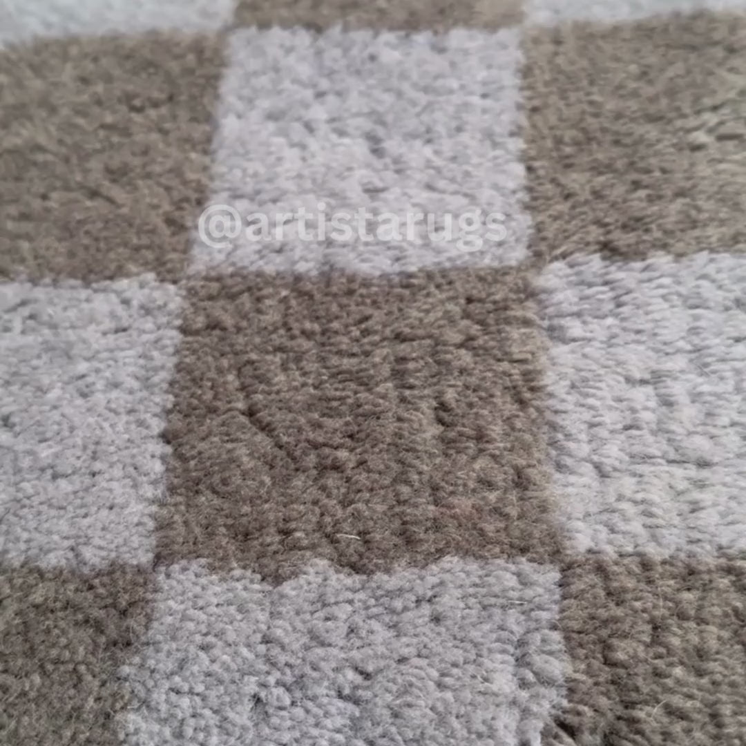 Rug with a plush texture and checkered squares, adding warmth to floors